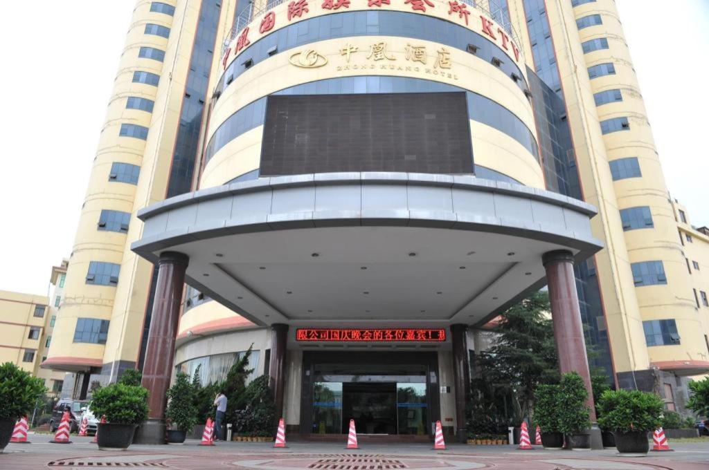 a large building with a sign in front of it at Kunming Zhong Huang Hotel in Kunming