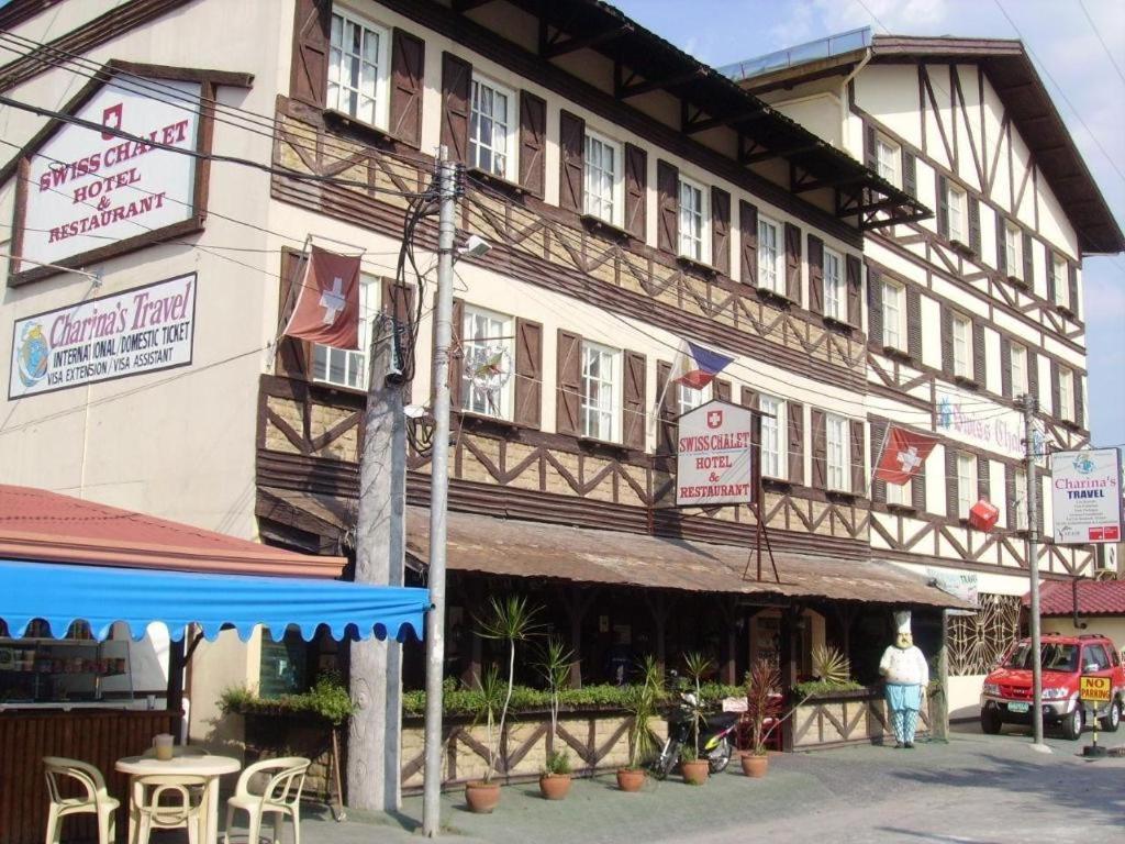 a man standing in front of a building at Swiss Chalet in Malabañas