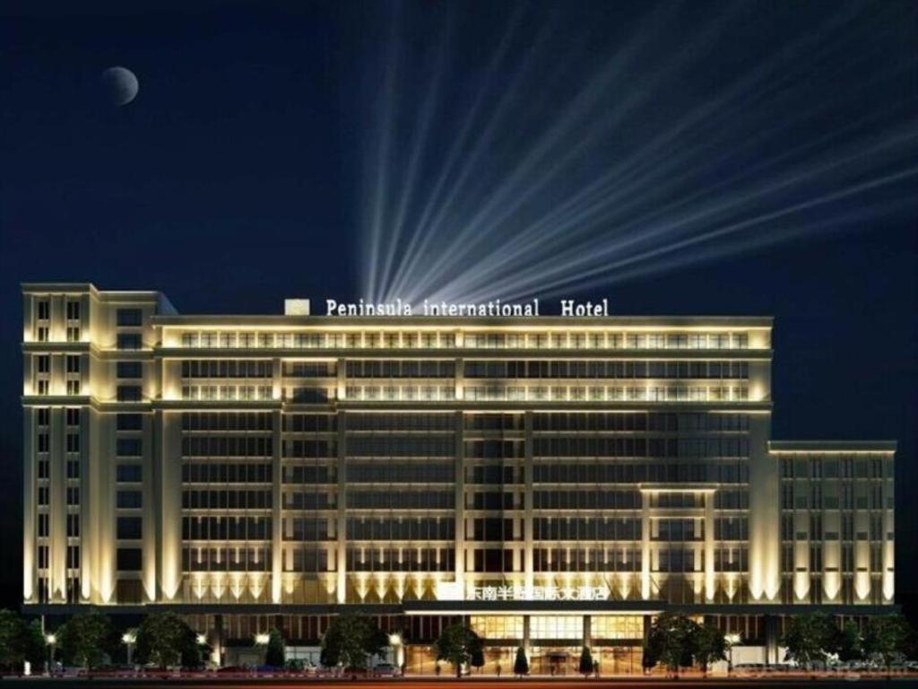 a large white building with the words paratus international hotel at Southeast Peninsula Hotel Quanzhou in Quanzhou