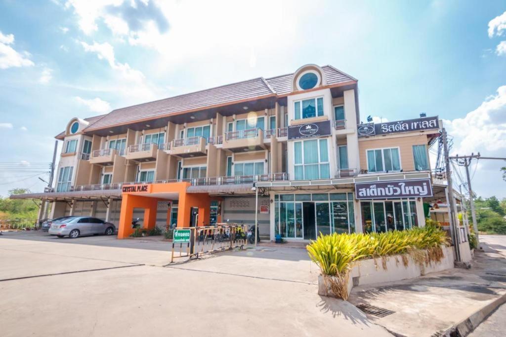 a large building with a sign on the front of it at Crystal Place Buayai in Bua Yai