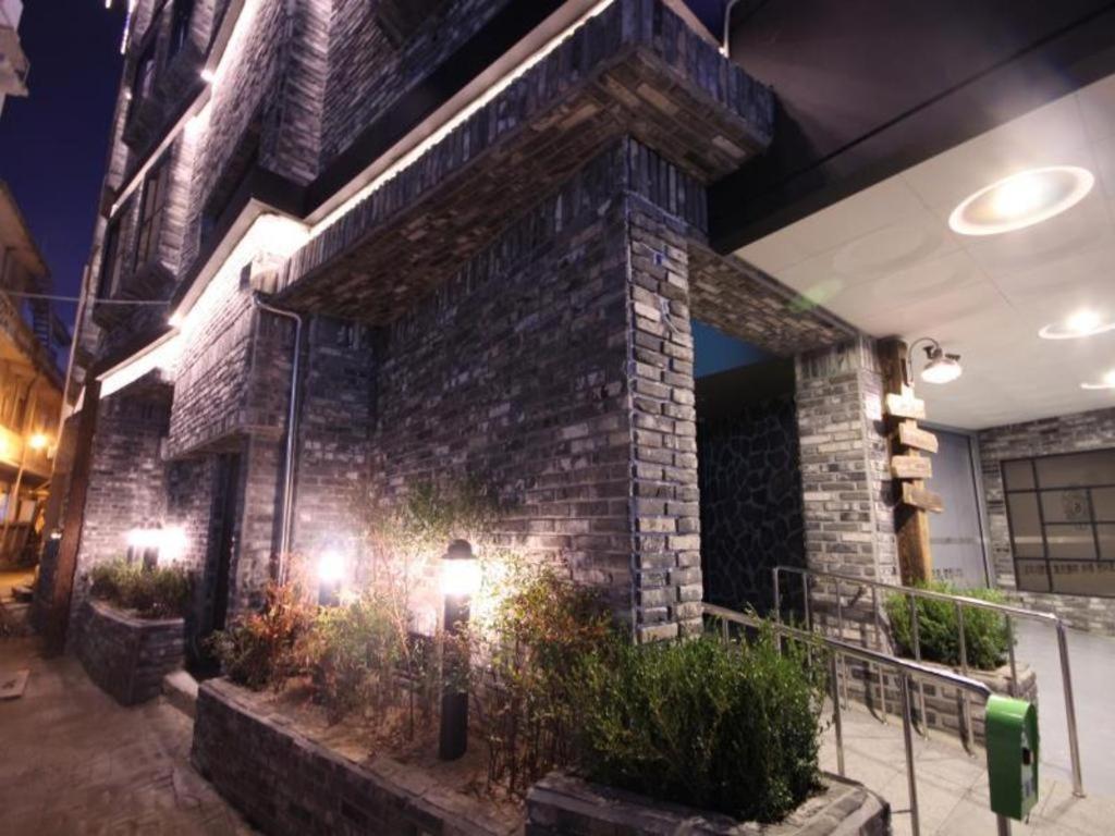 a brick building with plants on the side of it at Gallery Hotel in Daegu