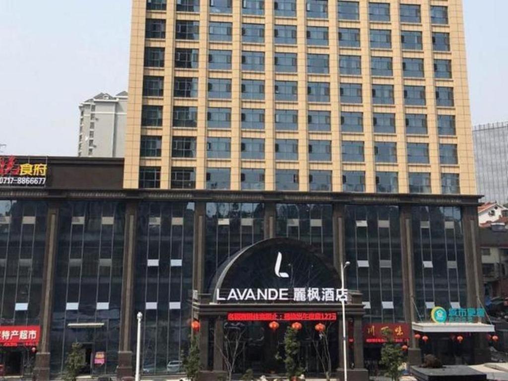 duży budynek z znakiem przed nim w obiekcie Lavande Hotel Yichang Railway East Station Branch w mieście Baiyang