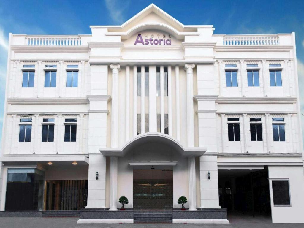 un bâtiment blanc avec un signe athée sur celui-ci dans l'établissement Hotel Astoria, à Lampung