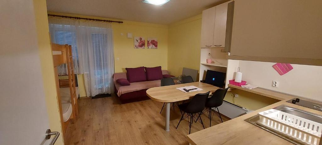 a small living room with a table and a couch at Apartma Gaber 110 in Zreče