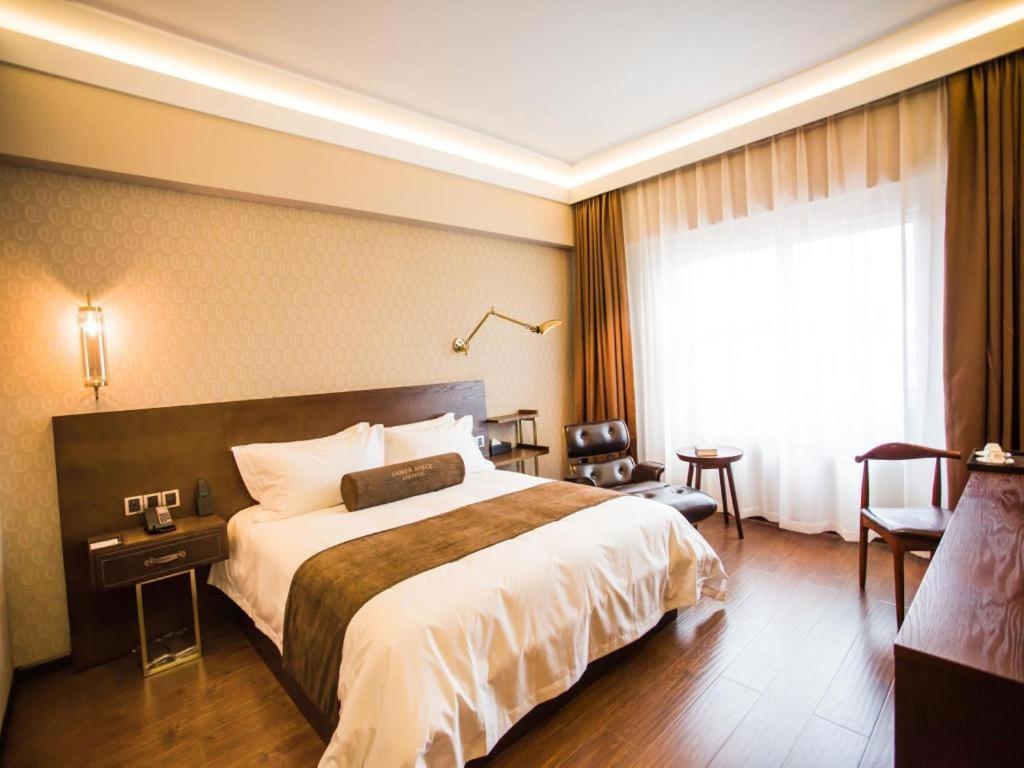 a hotel room with a large bed and a window at James Joyce Coffetel Chengdu Jianshe Road Dongjiao Jiyi Square in Chengdu