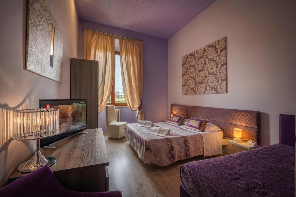 Postel nebo postele na pokoji v ubytování Hotel Palazzo Renieri - 3stelle S