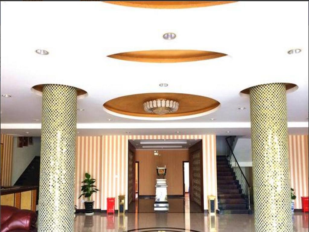 a large lobby with a large ceiling with columns at GreenTree Inn Shangrao Qianshan hekou old town Xinjiang longting shell hotel in Shangrao