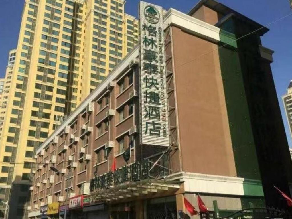 a building with a sign on the side of it at GreenTree Inn Taiyuan East Binhe Road Xiaodian High speed mouth Express Hotel in Kao-chung-ts'un