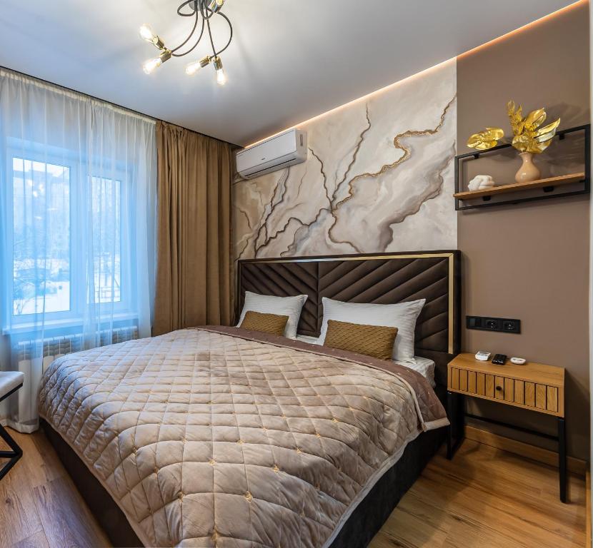 a bedroom with a large bed and a map on the wall at MYFREEDOM Апартаменти пр-т Правди 6 in Kyiv