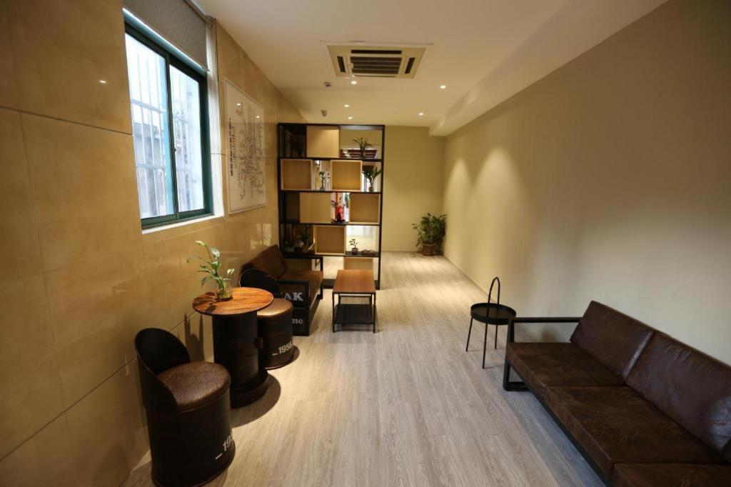 a living room with a couch and a table at Shanghai Jiejia hotel in Shanghai