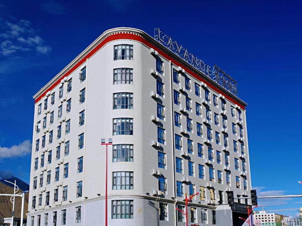 a tall white building with a red trim at Lavande Hotels Lhasa Municipal Government Tibet University in Lhasa