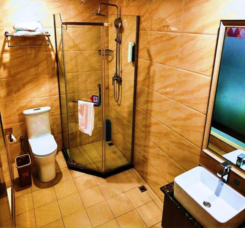 a bathroom with a shower and a toilet and a sink at PAI Hotels·Yinchuan International Trade City in Yinchuan