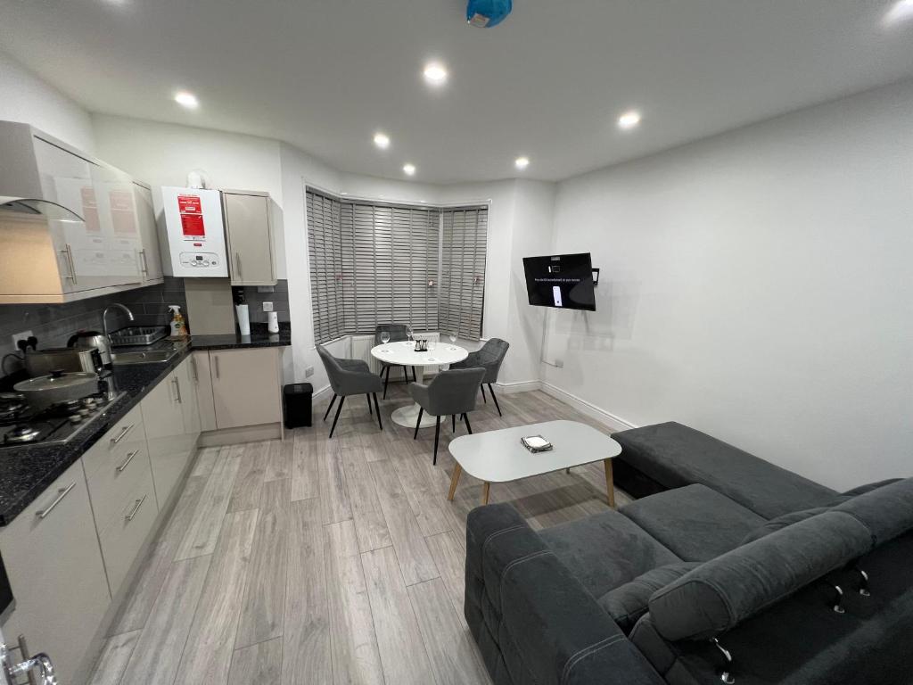 a living room with a couch and a table at F4 Luxury Stays One bed apartment with Parking in Ilford
