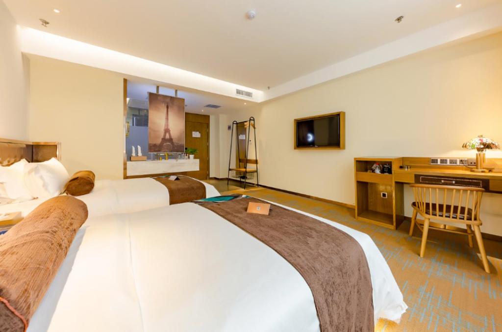 a hotel room with a large bed and a television at JAMES JOYCE COFFETEL ZIBO RAILWAY STATION STORE in Zibo