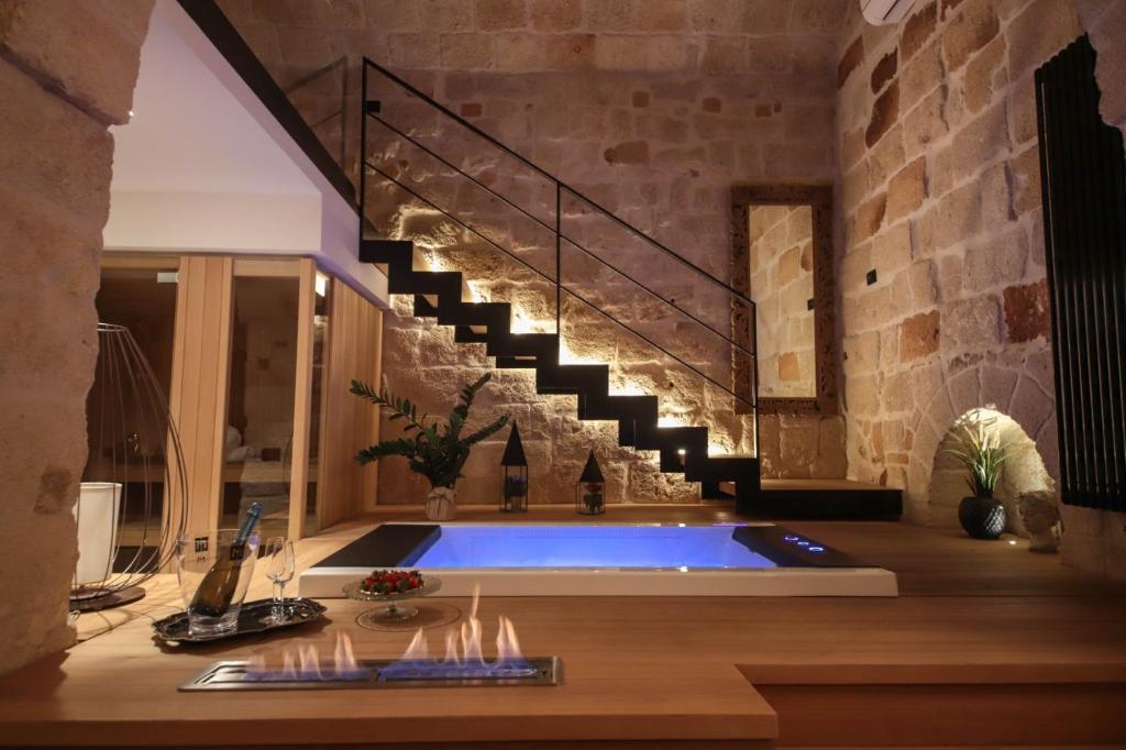 een badkamer met een hot tub en een trap bij SUITE & SPA VIA VENETO in Monopoli