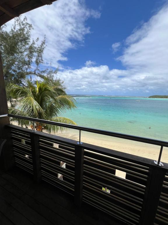 a view of the beach from a balcony at Blue Bay Beachfront 3 bedrooms Penthouse in Blue Bay