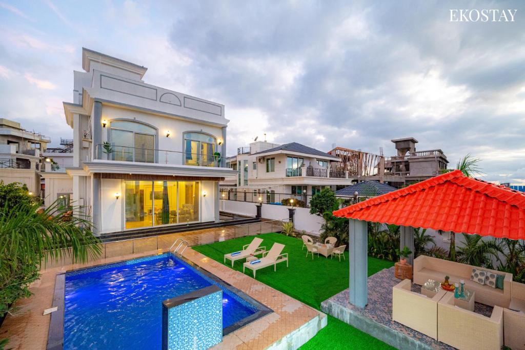 a villa with a swimming pool and a house at Ekostay Cliffside Villa I Mountain View in Lonavala