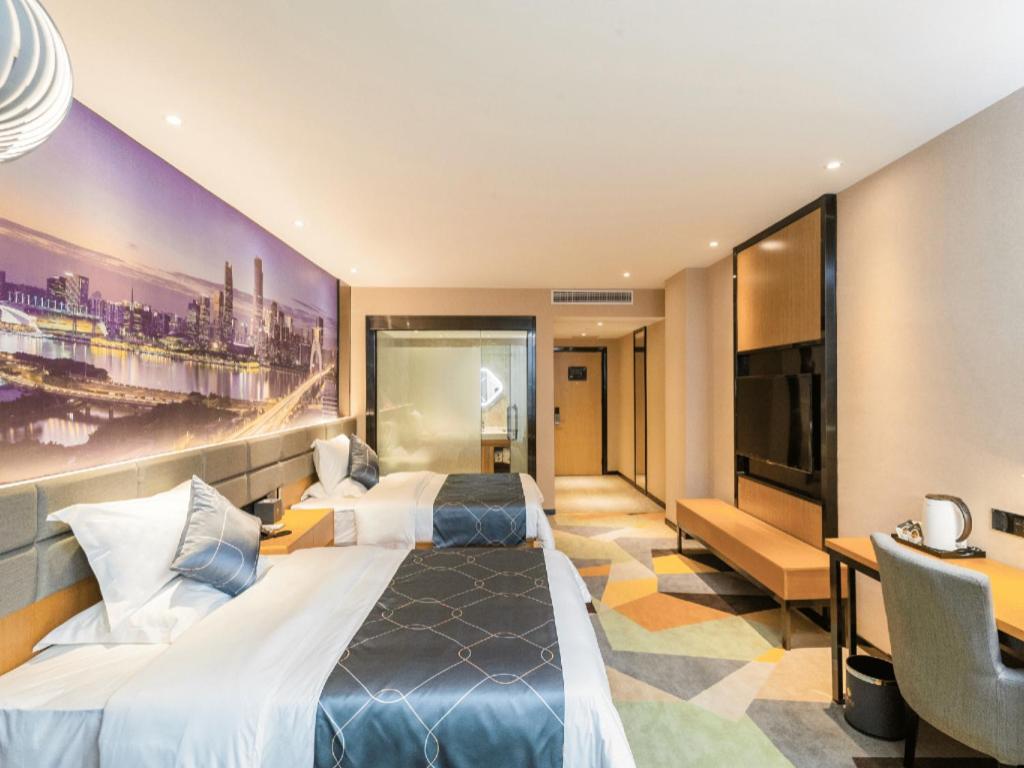 a hotel room with two beds and a flat screen tv at Chonpines Hotel Guangzhou Sunac Cultural and Tourism City Shiling in Huadu