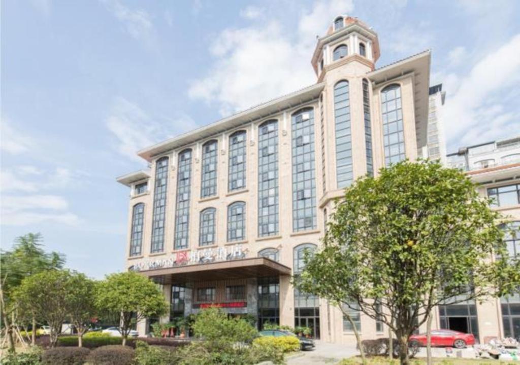 a large building with a clock tower on top of it at Borrman Hotel Liuzhou Guizhong Avenue Liugao in Liuzhou