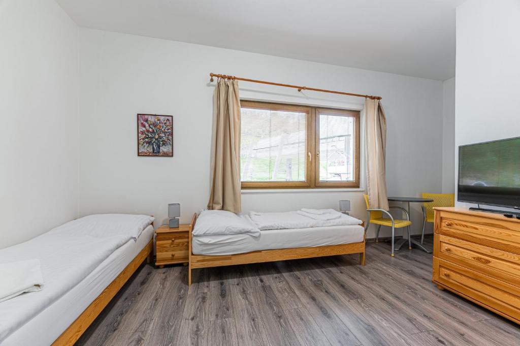 Postel nebo postele na pokoji v ubytování MEANDER THERMAL & SKI REZORT ORAVICE