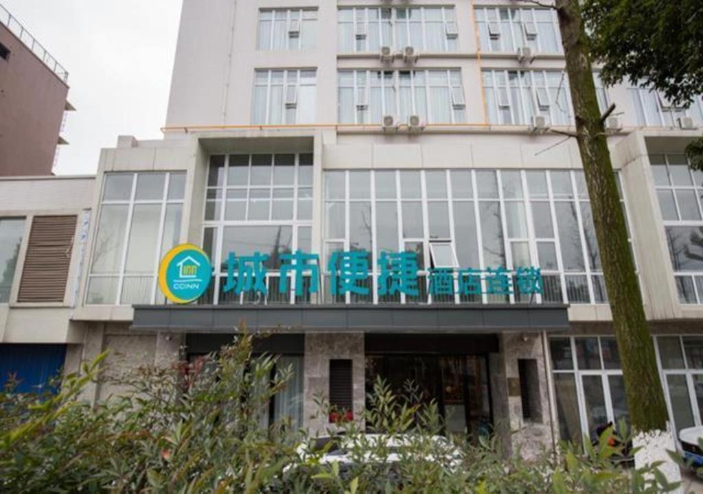 budynek z niebieskimi krzesłami na balkonie w obiekcie City Comfort Inn Deyang Shifang Yonghu Park w mieście Shifang