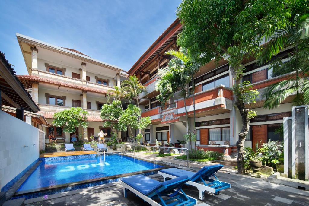 an apartment with a swimming pool in a building at Legian Village Beach Resort - CHSE Certified in Legian