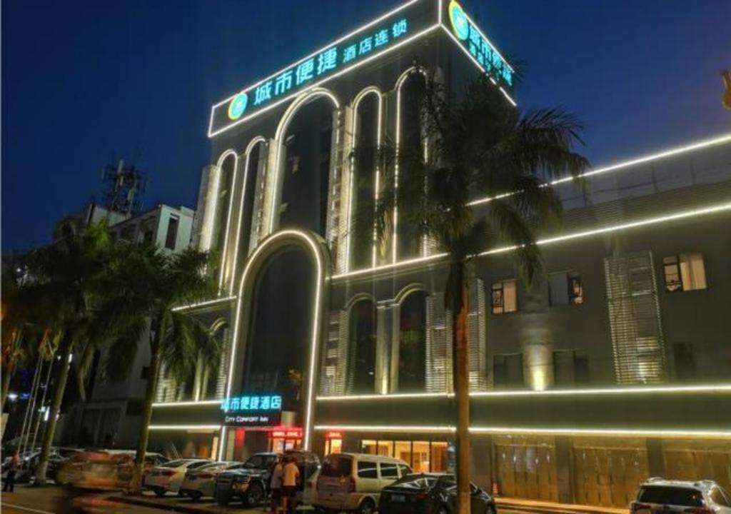 budynek z samochodami zaparkowanymi przed nim w nocy w obiekcie City Comfort Inn Hainan Tunchang Changsheng Road w mieście Tunchang
