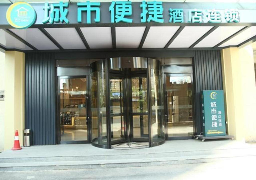 una entrada a un edificio con dos puertas giratorias en City Comfort Inn Shenyang Olympic Sports Center Wanda Plaza en Shenyang