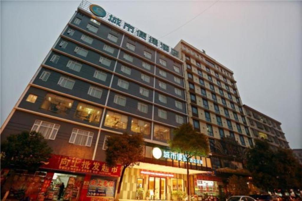 a tall building with a sign on top of it at City Comfort Inn Changsha Hunan Mass Media College in Xingsha