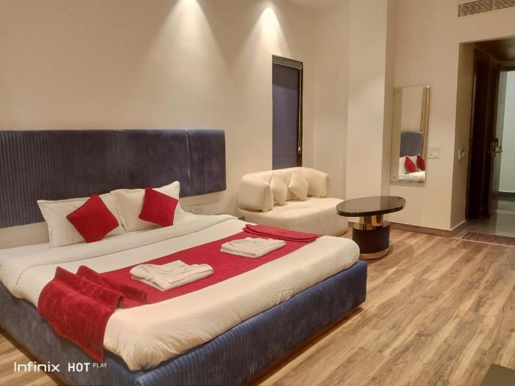 a hotel room with two beds and a table at Hotel 7 Days Inn Dharamshala in Dharamshala