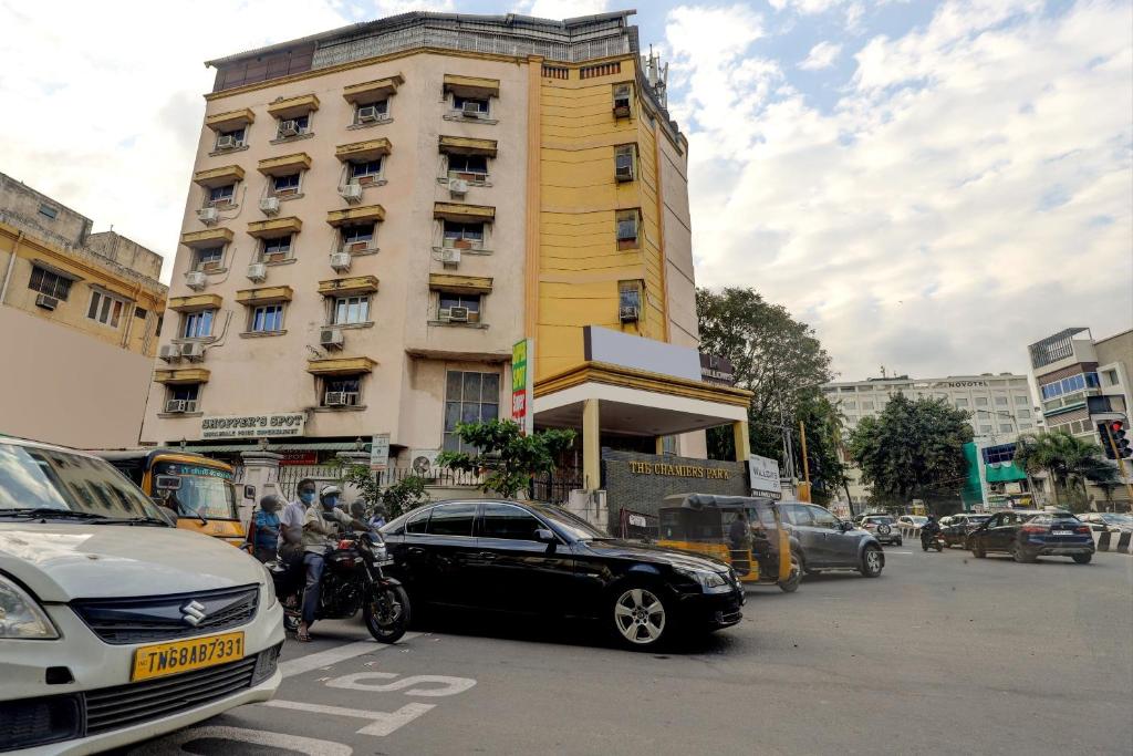 a black car parked in front of a yellow building at Collection O chamiers park in Chennai