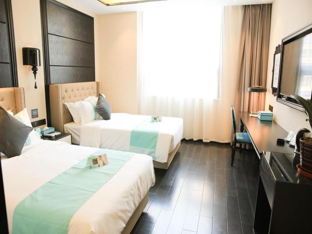 Ένα ή περισσότερα κρεβάτια σε δωμάτιο στο Xana Hotelle· Shijiazhuang Yaqing Street