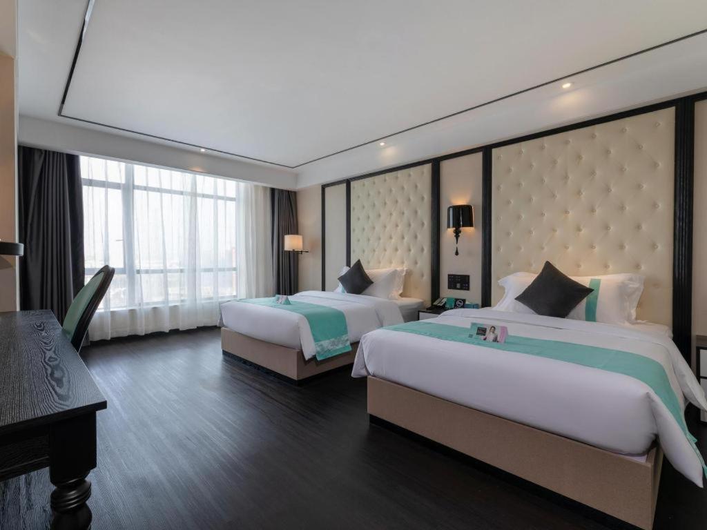 Krevet ili kreveti u jedinici u okviru objekta Xana Hotelle· Dongguang Chang'An Binhaiwan Jian'An Road
