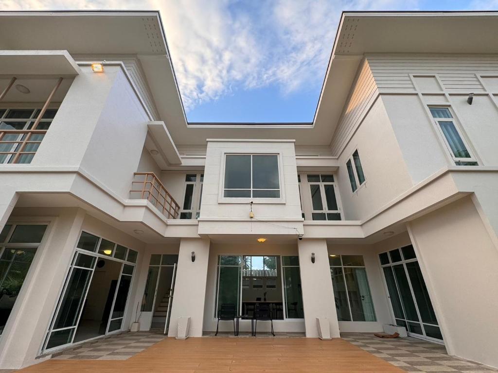 a large white house with a lot of windows at San Peak Villa in Sam Roi Yot