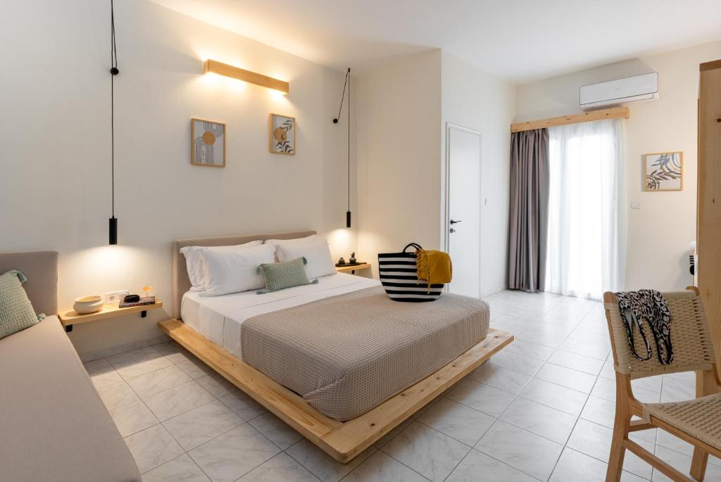 a bedroom with a bed with a wooden frame at Capella Town, Skiathos in Skiathos Town