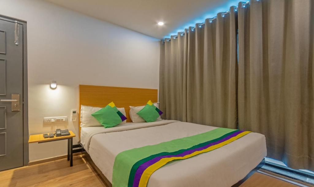 a bedroom with a large bed in a room at Treebo Trend The Square in Ahmedabad