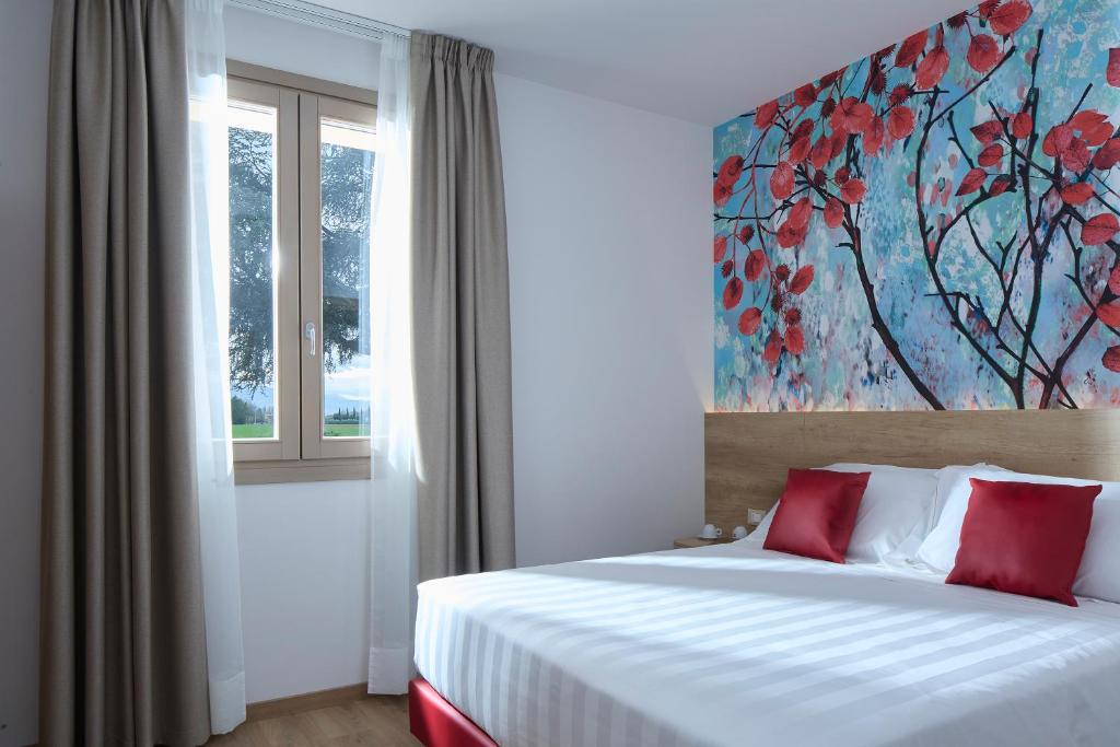 - une chambre avec un lit orné d'une peinture murale dans l'établissement Luci di Assisi B&B Wellness, à Assise