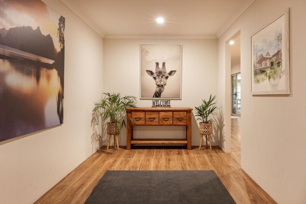 a hallway with a desk and a picture of a giraffe at Villa 16 @ Rivendell Winery Estate - Yallingup in Yallingup Siding