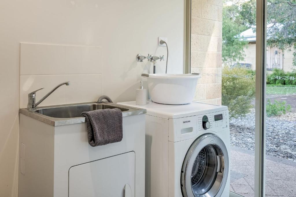 a kitchen with a washing machine and a sink at Villa 16 @ Rivendell Winery Estate - Yallingup in Yallingup Siding