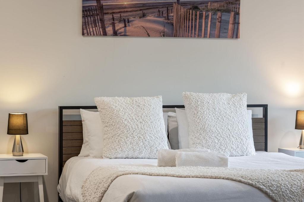 a bedroom with a bed with white sheets and pillows at Villa 16 @ Rivendell Winery Estate - Yallingup in Yallingup Siding