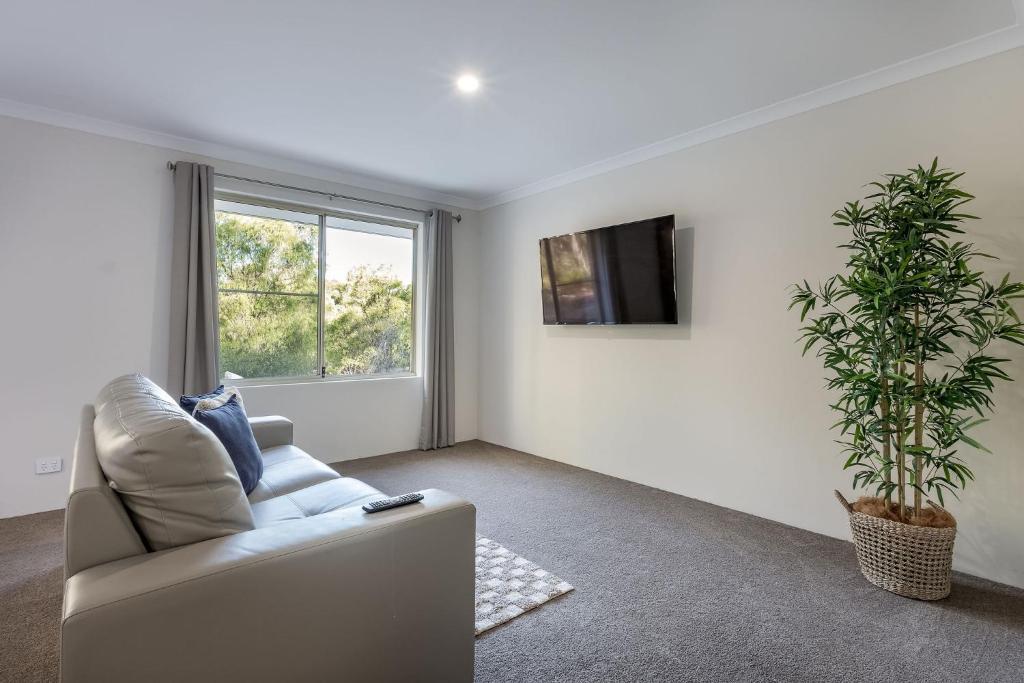 a living room with a couch and a plant at Villa 16 @ Rivendell Winery Estate - Yallingup in Yallingup Siding