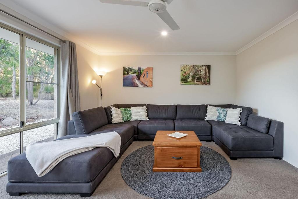 a living room with a couch and a table at Villa 16 @ Rivendell Winery Estate - Yallingup in Yallingup Siding