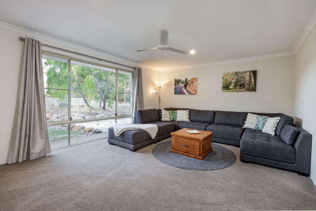 a living room with a couch and a table at Villa 16 @ Rivendell Winery Estate - Yallingup in Yallingup Siding