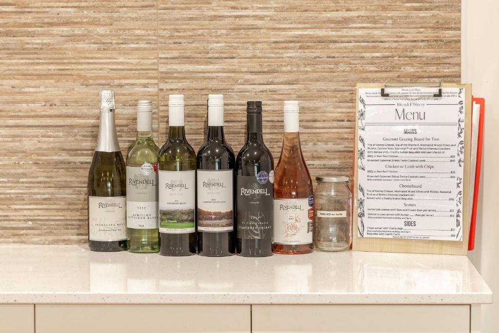 a group of bottles of wine sitting on a counter at Villa 16 @ Rivendell Winery Estate - Yallingup in Yallingup Siding