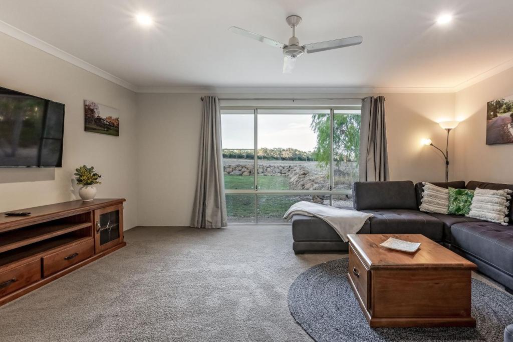 a living room with a couch and a tv at Villa 16 @ Rivendell Winery Estate - Yallingup in Yallingup Siding