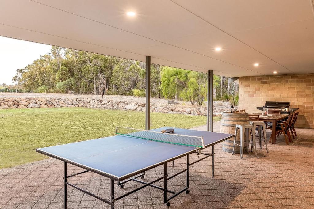 a ping pong table on a patio with a grill at Villa 16 @ Rivendell Winery Estate - Yallingup in Yallingup Siding