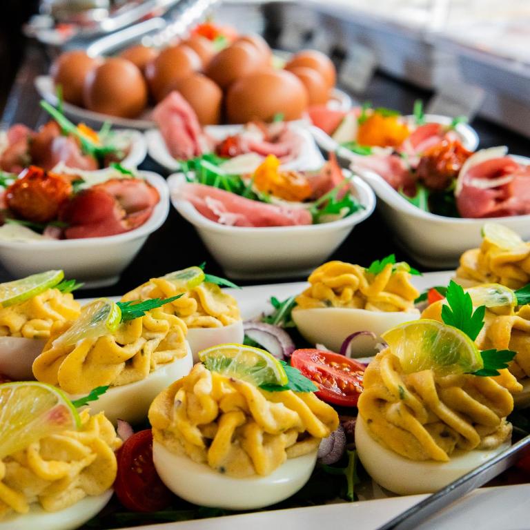 a buffet of eggs and other food on a table at The Hotel Unforgettable - Hotel Tiliana by Homoky Hotels & Spa in Budapest