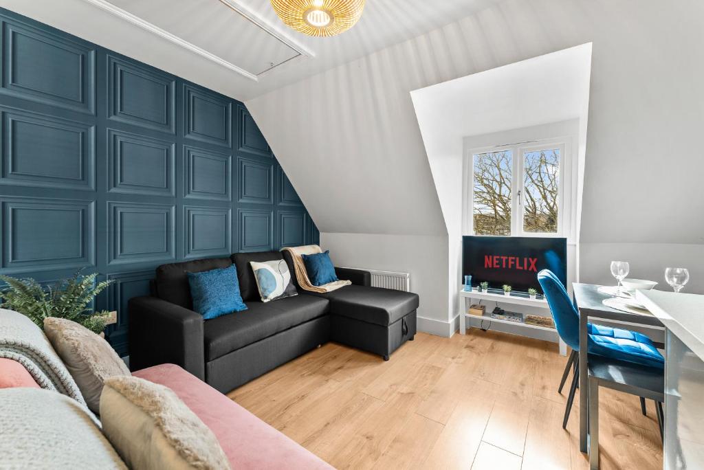 a living room with a couch and a table at The Chaucer - Stylish City Centre Gem - Sleeps 7 in Kent