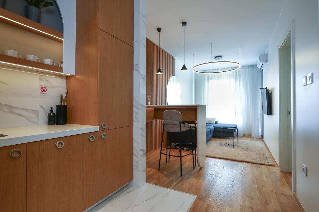 a kitchen with a table and a dining room at Apartment Sanja in Novi Sad