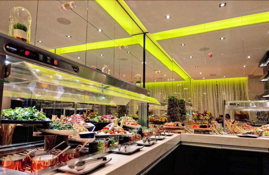 a buffet line of food in a restaurant at The Ciao Stelio Deluxe Boutique Hotel - Adults Only in Larnaka